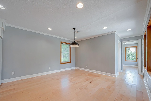 unfurnished room featuring ornamental molding, a textured ceiling, and light hardwood / wood-style floors