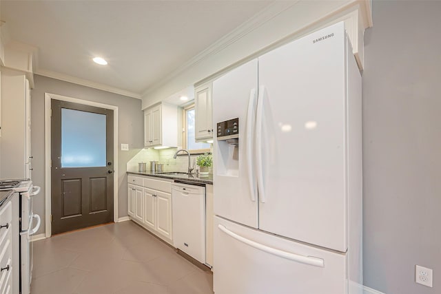 kitchen featuring sink, backsplash, white cabinets, ornamental molding, and white appliances