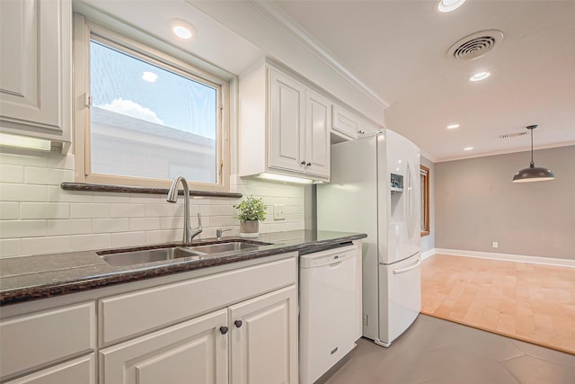 kitchen with pendant lighting, sink, white appliances, white cabinetry, and ornamental molding