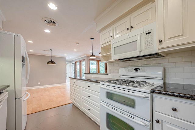 kitchen with crown molding, white appliances, decorative light fixtures, and decorative backsplash