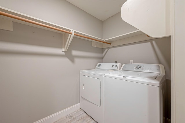 laundry room featuring light hardwood / wood-style floors and independent washer and dryer