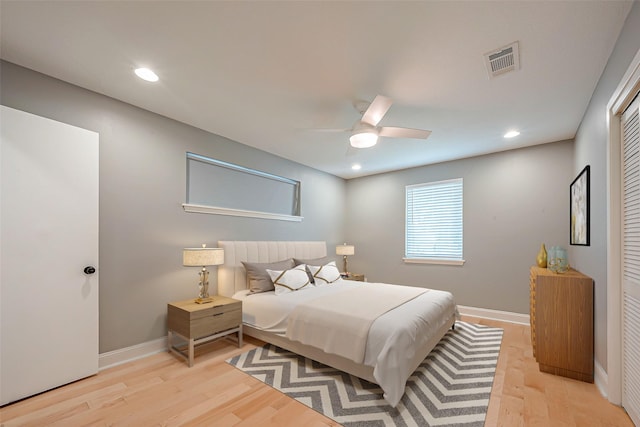 bedroom with ceiling fan and light hardwood / wood-style floors