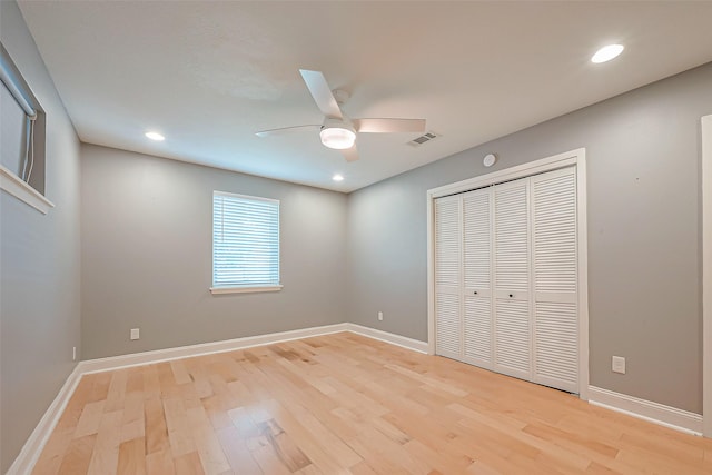 unfurnished bedroom with ceiling fan, light hardwood / wood-style floors, and a closet