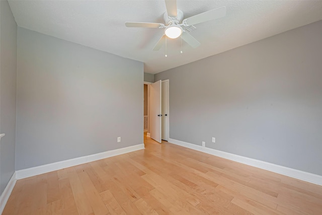 empty room featuring ceiling fan, a textured ceiling, and light hardwood / wood-style floors