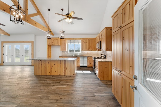 kitchen featuring backsplash, a center island, light stone counters, stainless steel appliances, and dark wood-type flooring