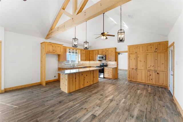 kitchen with dark hardwood / wood-style flooring, decorative backsplash, stainless steel appliances, and a center island