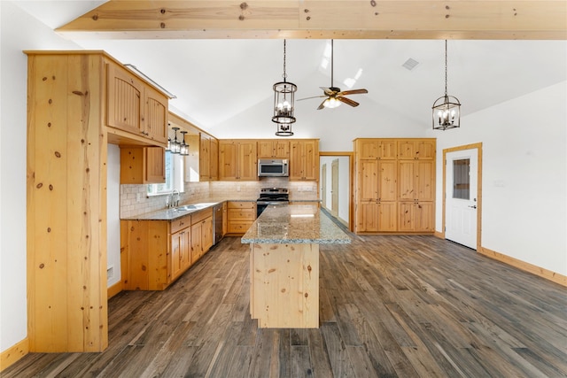 kitchen featuring appliances with stainless steel finishes, dark wood-type flooring, light stone counters, decorative backsplash, and a center island