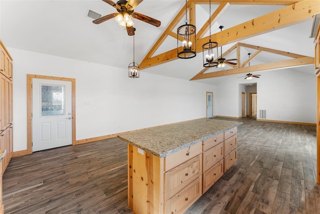 kitchen with light stone counters, a center island, dark wood-type flooring, light brown cabinets, and hanging light fixtures