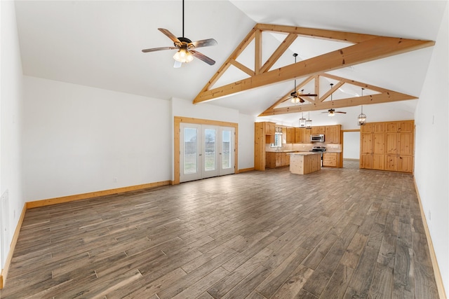 unfurnished living room with ceiling fan, high vaulted ceiling, dark hardwood / wood-style flooring, and french doors