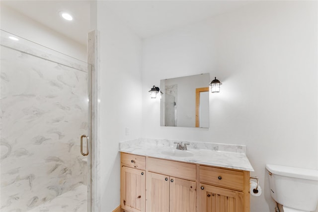 bathroom featuring walk in shower, vanity, and toilet