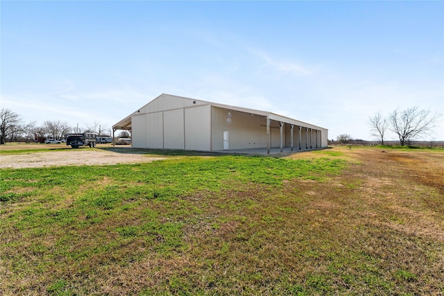 exterior space featuring an outbuilding and a lawn