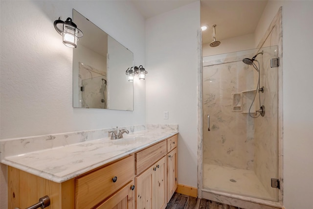 bathroom featuring vanity and an enclosed shower