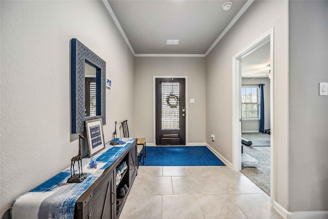 tiled foyer entrance featuring ornamental molding