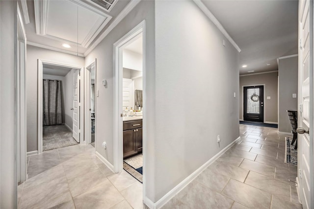 corridor with crown molding and light tile patterned floors