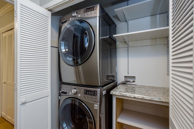 washroom with stacked washer / drying machine