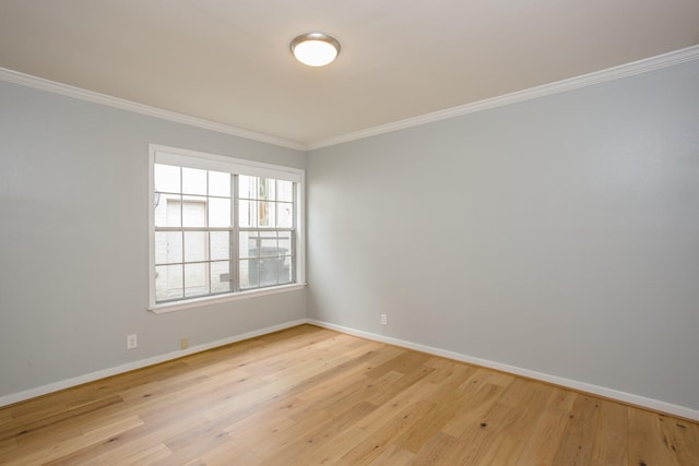 spare room with light hardwood / wood-style flooring and ornamental molding