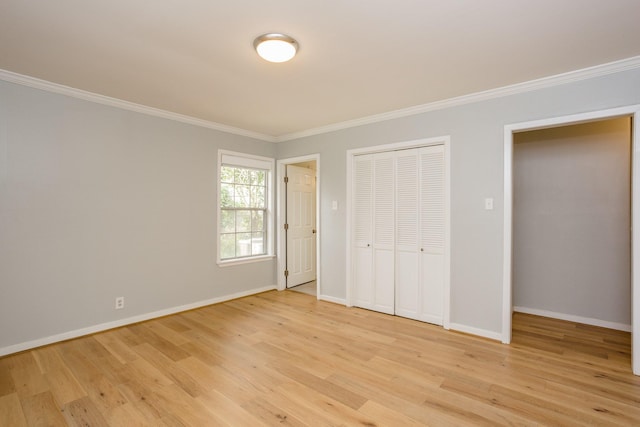 unfurnished bedroom with crown molding, light hardwood / wood-style flooring, and a closet