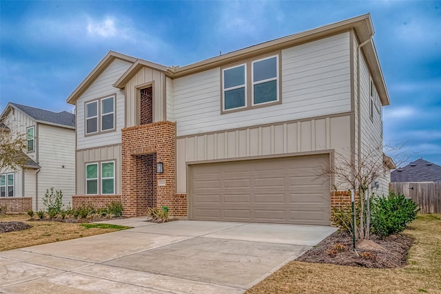 view of front of house with a garage, brick siding, fence, concrete driveway, and board and batten siding