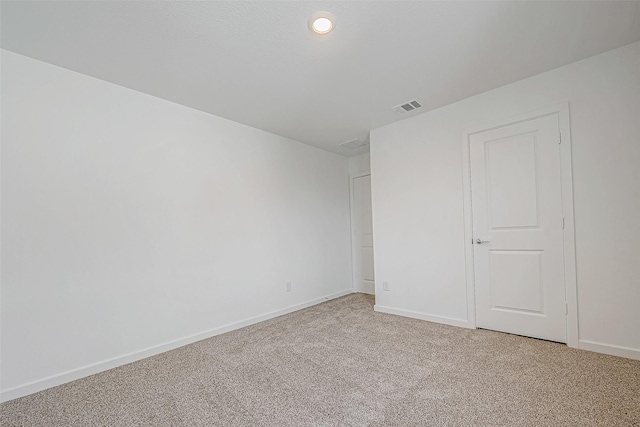 unfurnished bedroom with light carpet, visible vents, and baseboards