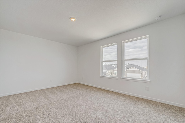 carpeted spare room with recessed lighting and baseboards