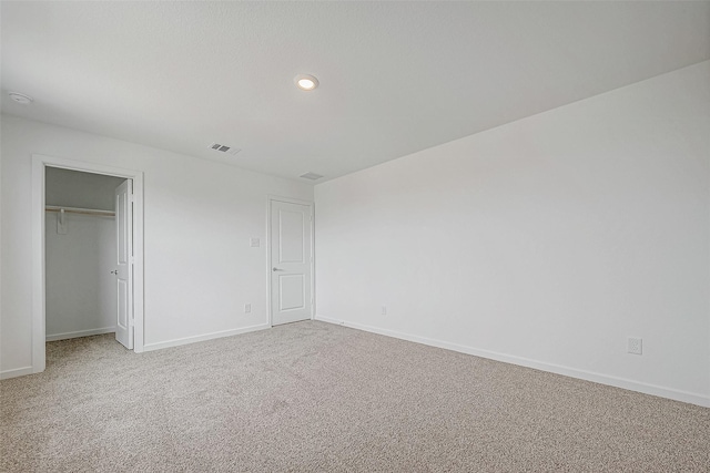 unfurnished bedroom with carpet, baseboards, a closet, and recessed lighting