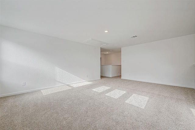 carpeted spare room with recessed lighting, visible vents, and baseboards