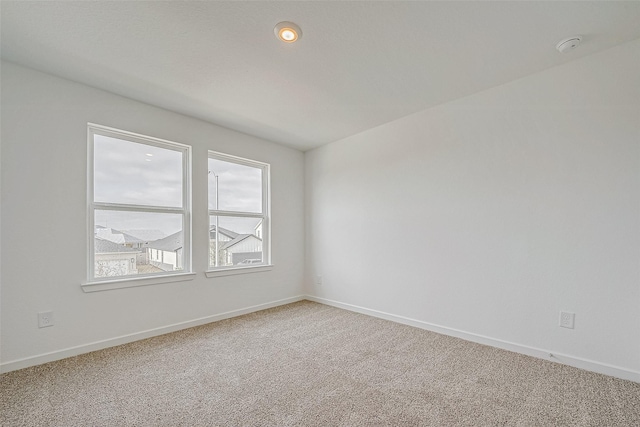 empty room with carpet floors and baseboards