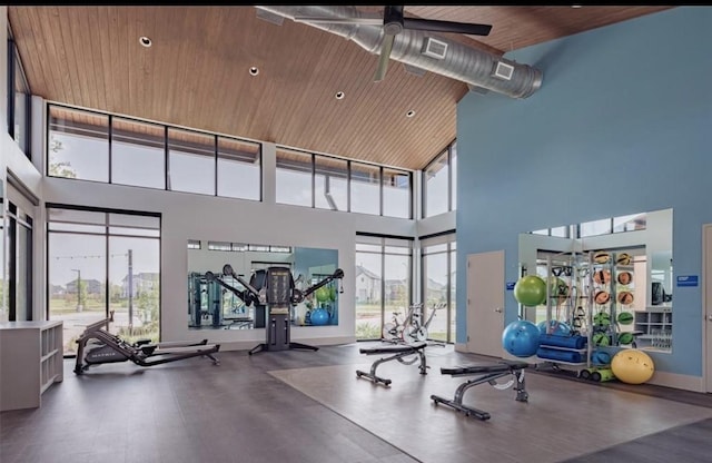 workout area with a healthy amount of sunlight, wooden ceiling, baseboards, and a ceiling fan