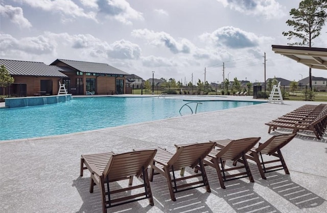 community pool featuring a patio area and fence