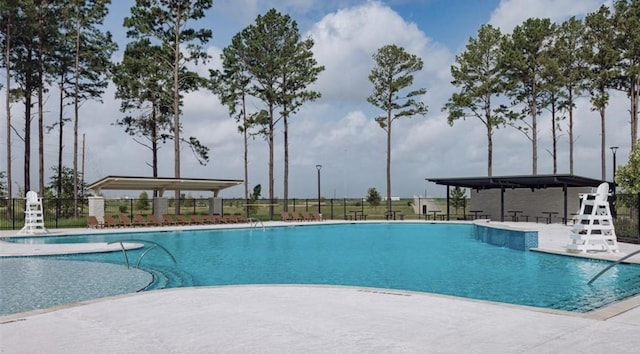 pool featuring a patio area and fence