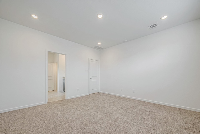 unfurnished room with baseboards, recessed lighting, visible vents, and light colored carpet