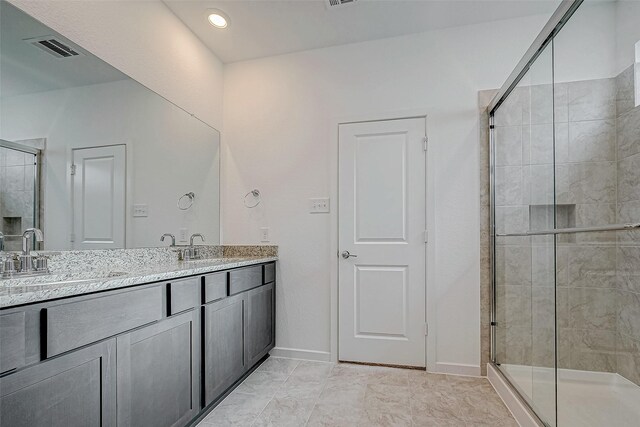 bathroom with double vanity, a sink, visible vents, and a shower stall