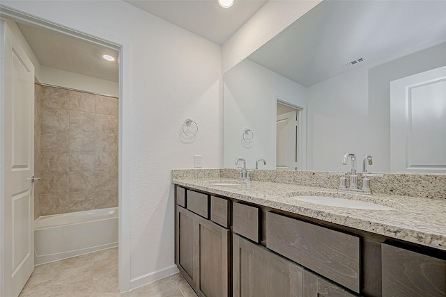 bathroom with double vanity, visible vents, a sink, and bathing tub / shower combination