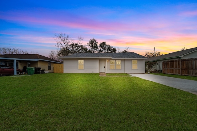 ranch-style home featuring a lawn