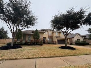 view of front facade featuring a garage and a front lawn