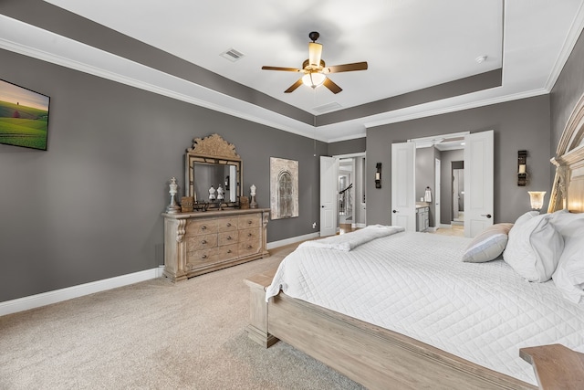 carpeted bedroom with ornamental molding, a tray ceiling, visible vents, and baseboards