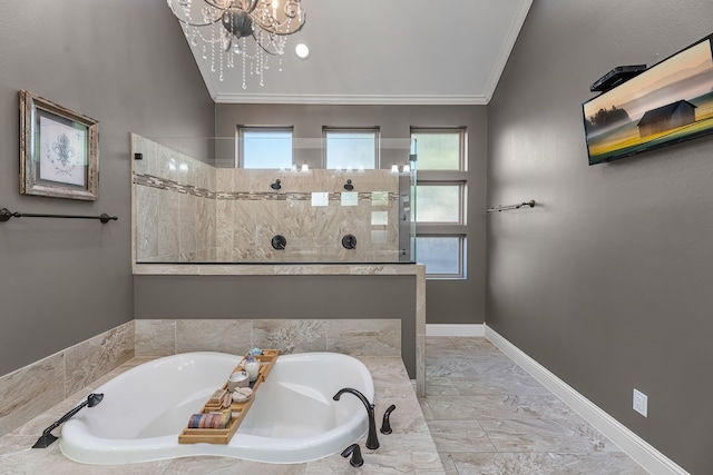 bathroom featuring baseboards, ornamental molding, a garden tub, an inviting chandelier, and a walk in shower