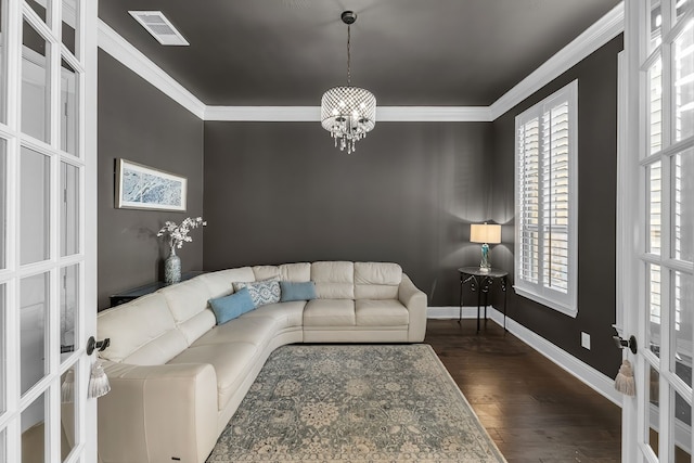 living area featuring visible vents, ornamental molding, dark wood finished floors, and french doors