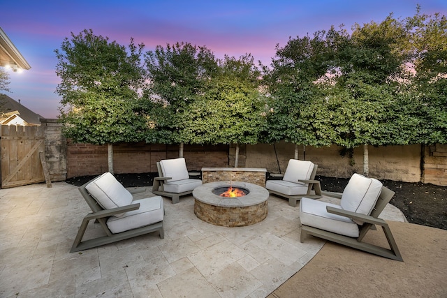 view of patio with an outdoor fire pit and fence