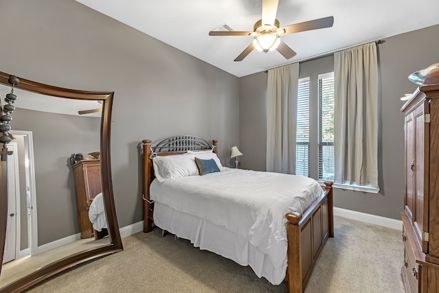 bedroom with baseboards, a ceiling fan, and light colored carpet