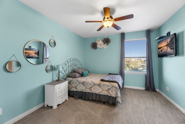 bedroom featuring a ceiling fan, light carpet, and baseboards