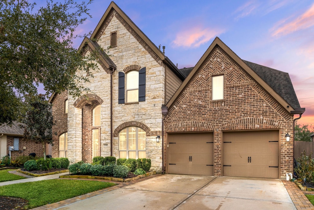 french provincial home with a garage