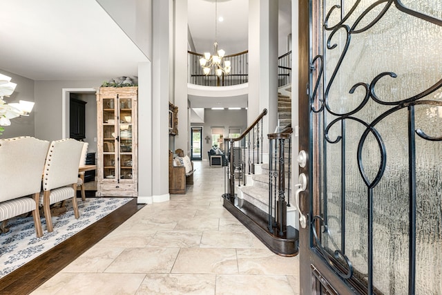 foyer entrance with a towering ceiling and an inviting chandelier