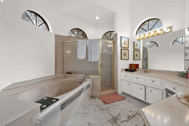 bathroom with vanity and independent shower and bath