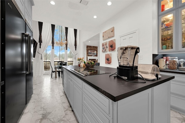 kitchen featuring gray cabinets, black appliances, and a kitchen island