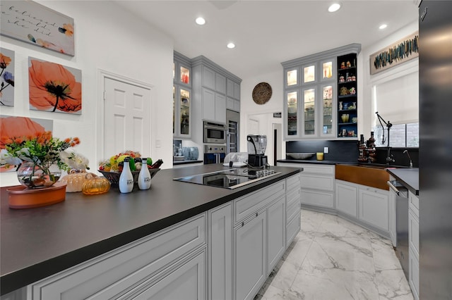 kitchen with black electric cooktop, sink, gray cabinets, and stainless steel dishwasher