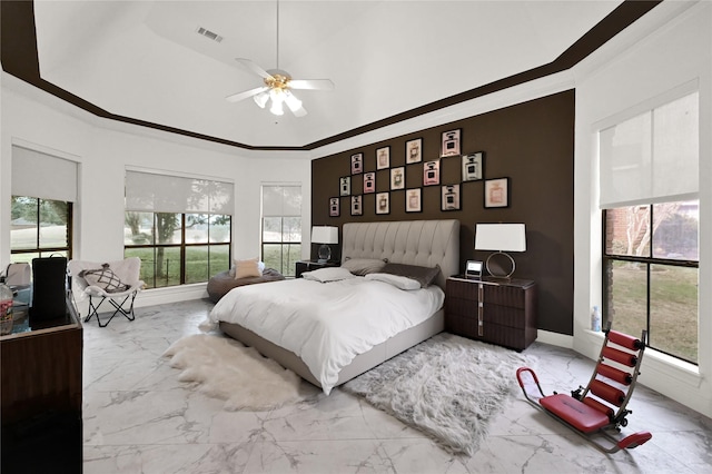 bedroom with ornamental molding and ceiling fan