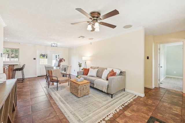 tiled living room featuring ornamental molding and ceiling fan