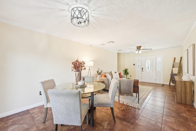 tiled dining room with crown molding, ceiling fan with notable chandelier, and a textured ceiling