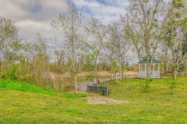 view of yard featuring a gazebo and a water view